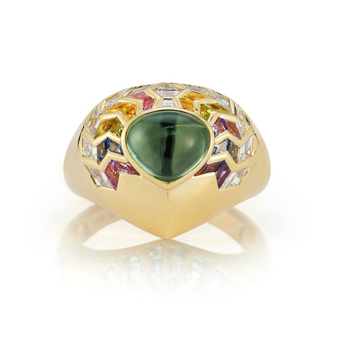 Behold the captivating elegance of our Wishing Well Shield Ring in Feather. Crafted to perfection, this exquisite ring features a stunning shield design adorned with hand-carved multi-colored stones and diamonds, exuding a sense of grace and sophistication. With its intricate details and vibrant gemstones, this ring is sure to make a statement. Add a touch of luxury to your collection today!