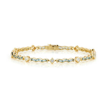 Load image into Gallery viewer, The Awakenings Tennis Bracelet in Water by ARK Fine Jewelry is a delicate and elegant piece crafted in 18 karat yellow gold. It features a continuous line of sparkling princess-cut diamonds and aquamarine gemstones, symbolizing the fluidity and serenity of water. Each gemstone is meticulously set, creating a seamless and graceful look that enhances any wrist. This luxurious bracelet is perfect for adding a touch of sophistication and tranquility to your jewelry collection.