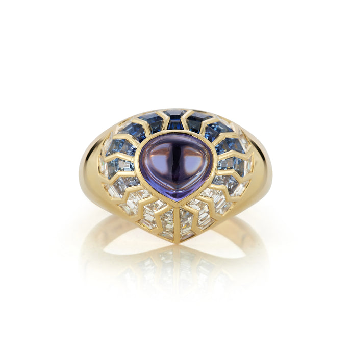 Close-up image of the Aphrodite Shield Ring with Blue Aura. The ring features intricate detailing and a vibrant blue aura gemstone at its center, reminiscent of the goddess Aphrodite. The shield-shaped design adds an elegant touch to the jewelry piece.